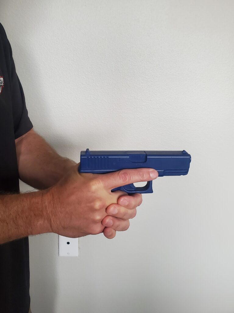 A man holding a blue gun in his hand.