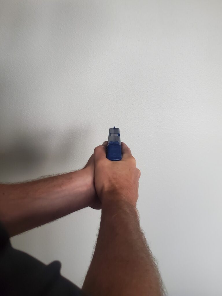 A person holding a blue object in their hand.